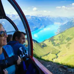 Folk i linbana njuter av alpina vyer. Undrar du vad kostar det att tågluffa i Europa? Denna vy är en del av en fantastisk resa.