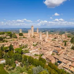 En medeltida stad i Toscana, med sina karakteristiska torn som sträcker sig mot en klarblå himmel.