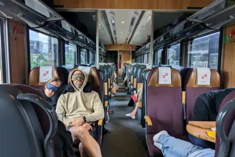Två personer sover med sovmasker på ett tåg, redo för en lång resa med SJ Euronight.