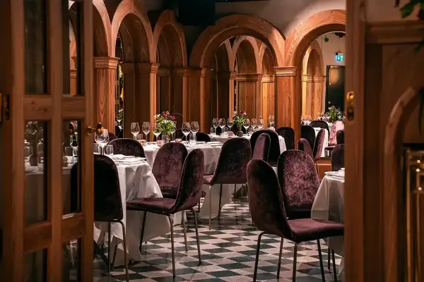 Elegant bank hotel lunch setting with plush chairs and arched wooden decor.